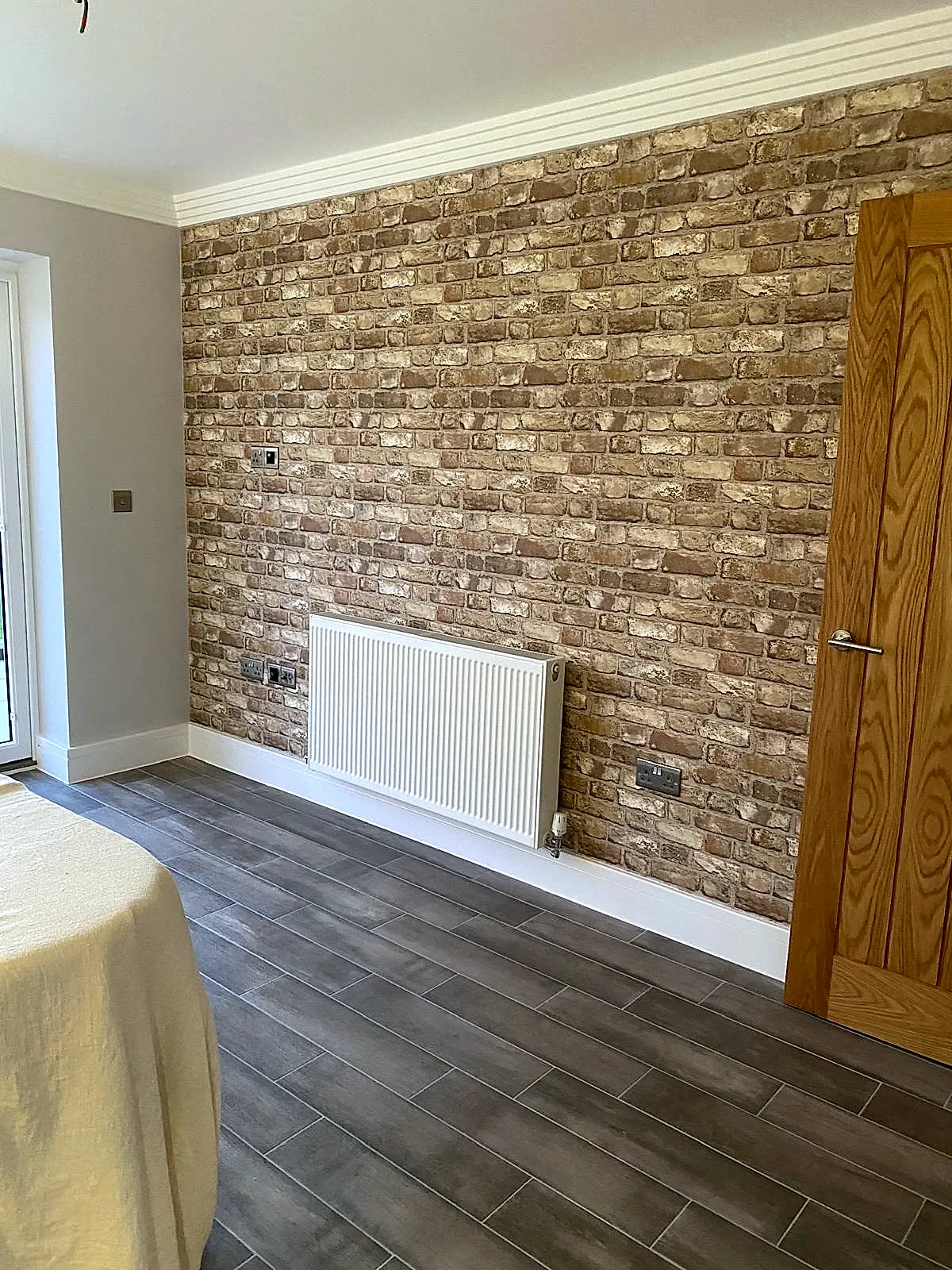 Medbourne — Brick-effect feature wall in hallway